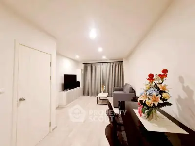 Modern living room with elegant decor and spacious layout, featuring a cozy sofa and stylish dining area.