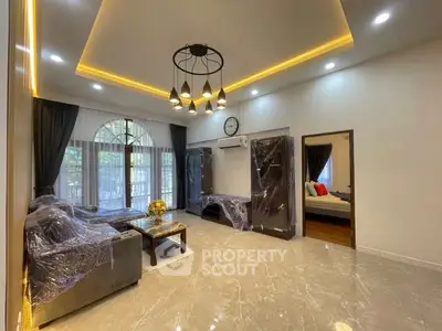 Spacious modern living room with elegant lighting and large windows