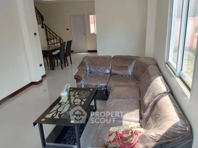 Spacious living room with modern sectional sofa and elegant dining area