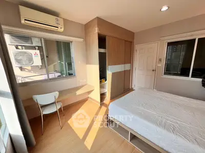 Bright and cozy bedroom with modern furnishings and ample natural light.
