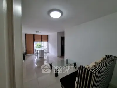 Modern living room with sleek furniture and natural light in a contemporary apartment.