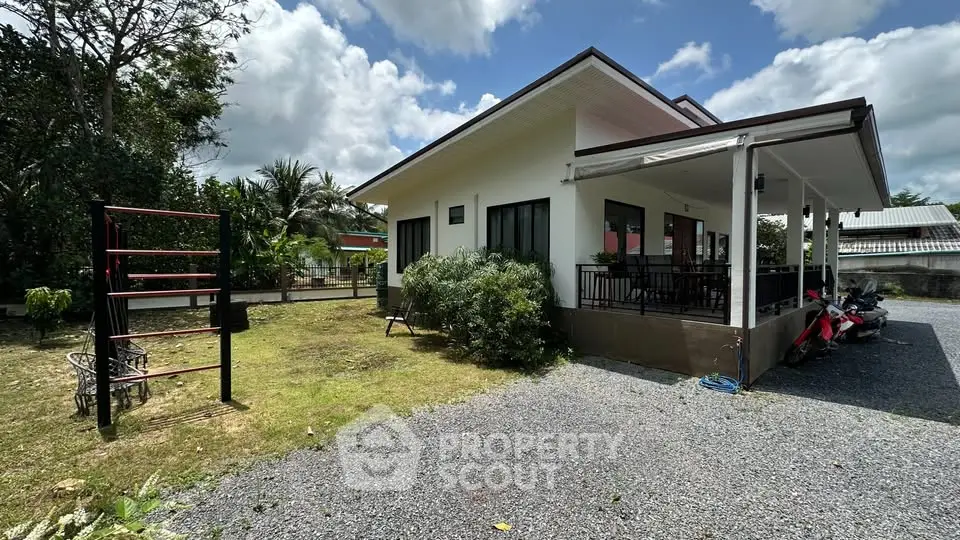 Charming single-story house with spacious yard and covered porch, perfect for family living in a serene neighborhood.