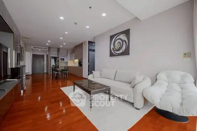 Spacious modern living room with elegant furniture and open kitchen layout