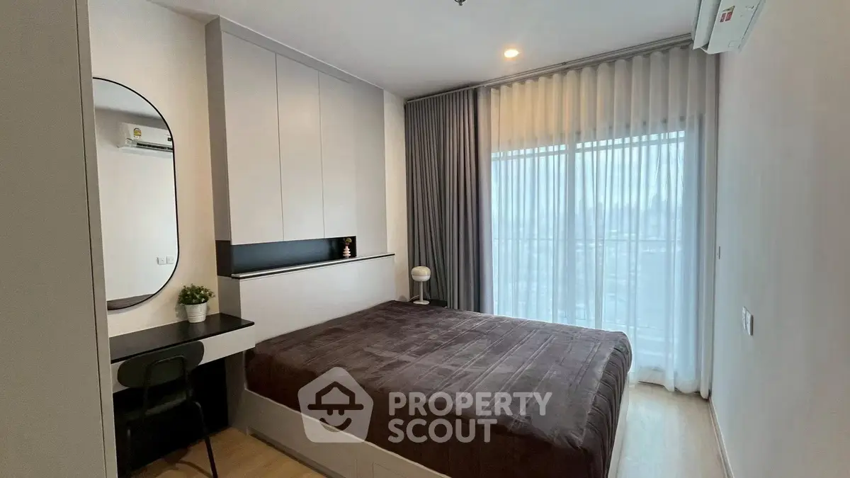 Modern bedroom with large window and stylish decor