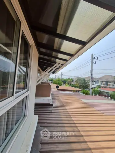 Spacious balcony with modern roofing and scenic neighborhood view