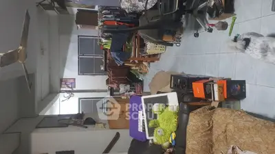 Cluttered living space with various items and furniture, showcasing potential for organization.