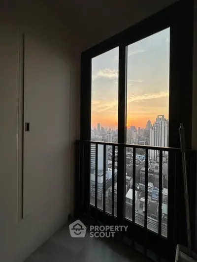 Stunning cityscape view from a modern high-rise balcony at sunset, perfect for urban living enthusiasts.