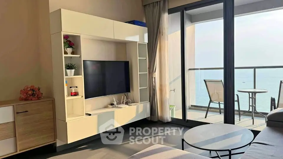 Modern living room with ocean view balcony and stylish furniture