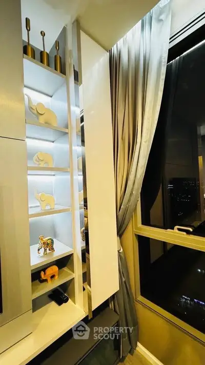 Stylish modern living room with elegant shelving and city view window.