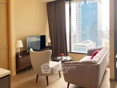 Modern living room with city view, featuring stylish furniture and large windows.