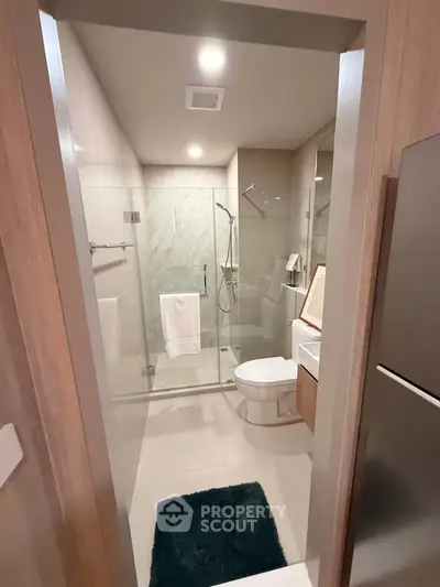 Modern bathroom with glass shower and sleek fixtures