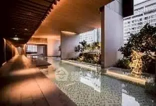 Luxurious indoor pool with modern design and ambient lighting in upscale building.