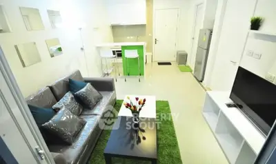 Modern living room with sleek furniture and open kitchen layout in a stylish apartment.