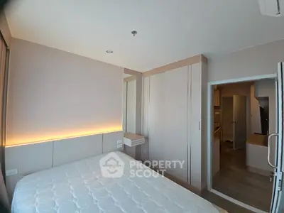 Modern bedroom with built-in wardrobe and ambient lighting