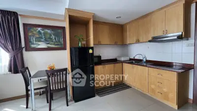 Charming kitchen with wooden cabinets and dining area, perfect for cozy meals.