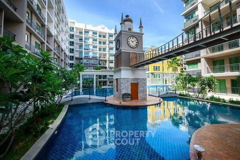 Luxurious condominium with stunning pool and unique clock tower feature.