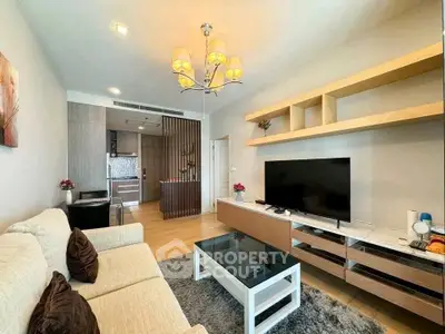 Modern living room with elegant decor and open kitchen layout in a stylish apartment.