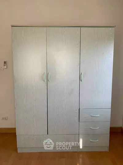 Spacious wooden wardrobe with sleek design and ample storage in a modern interior setting.