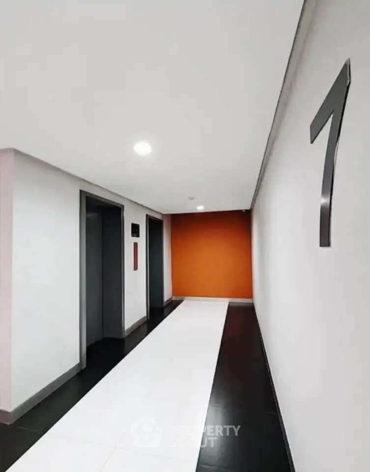 Modern building corridor with elevators and stylish design on the seventh floor.