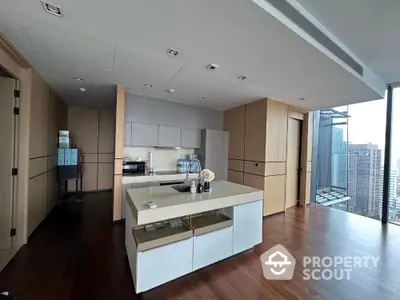 Modern kitchen with island and city view in luxury apartment