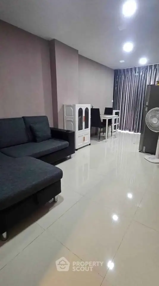 Modern living room with sleek furniture and glossy tiled floors