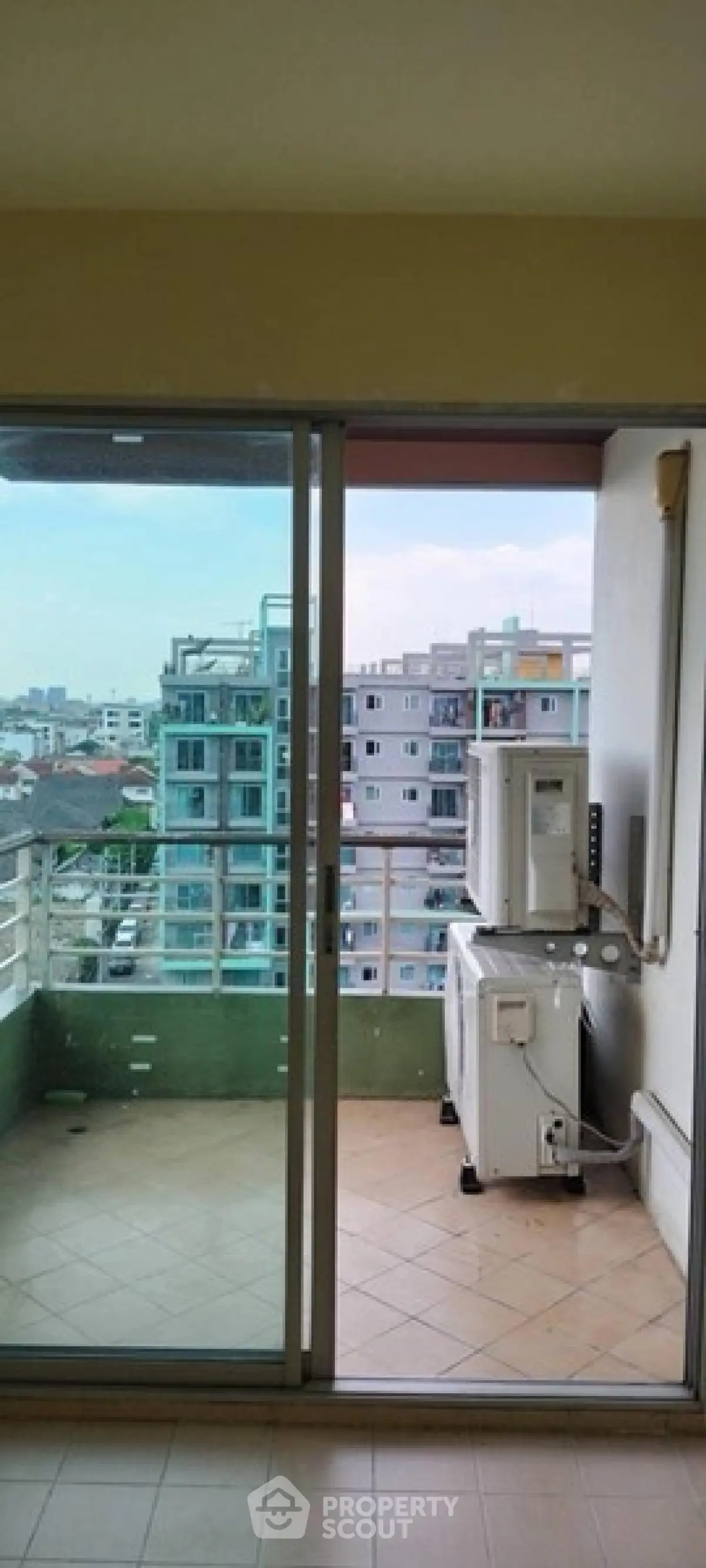 Spacious balcony with city view in modern apartment building.