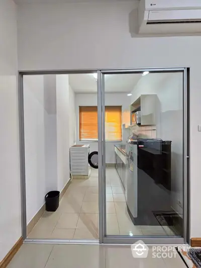 Modern kitchen with sliding glass door and washing machine