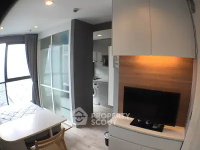 Modern studio apartment with sleek design, featuring a cozy living area, compact kitchen, and large windows with city views.