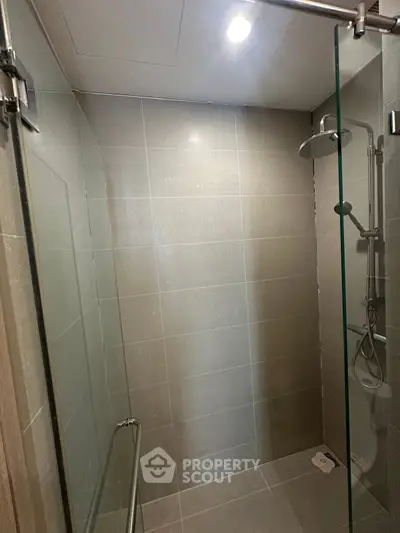 Modern bathroom with sleek glass shower enclosure and contemporary fixtures.