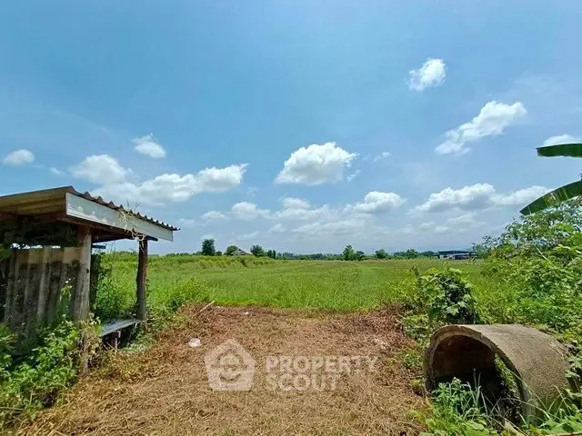 Expansive rural land with clear blue sky, perfect for development or agriculture.