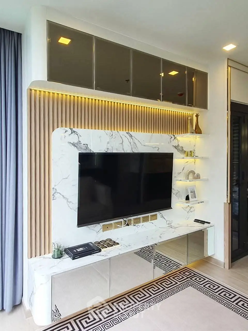 Luxurious modern living room with marble TV wall and elegant shelving