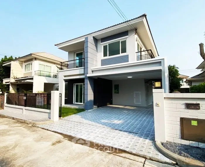 Modern two-story house with spacious driveway and contemporary design