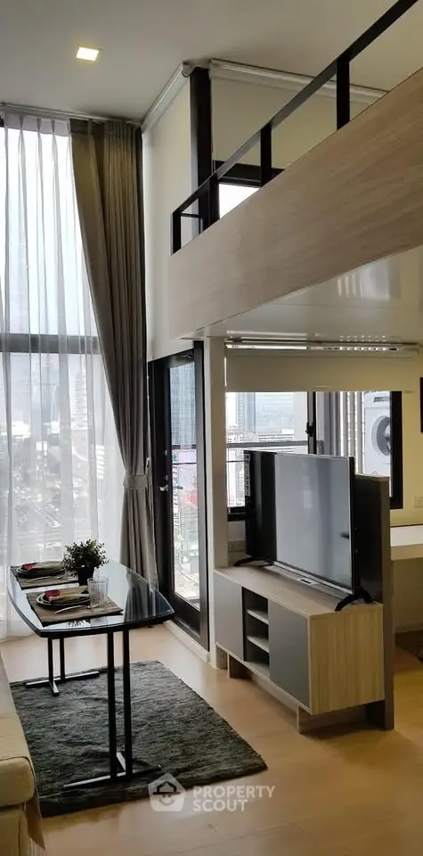 Modern loft apartment with high ceilings and large windows offering city views, featuring a stylish living area and mezzanine.