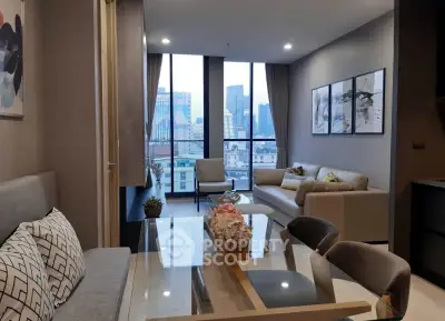 Modern living room with city view, stylish decor, and elegant furniture in a high-rise apartment.