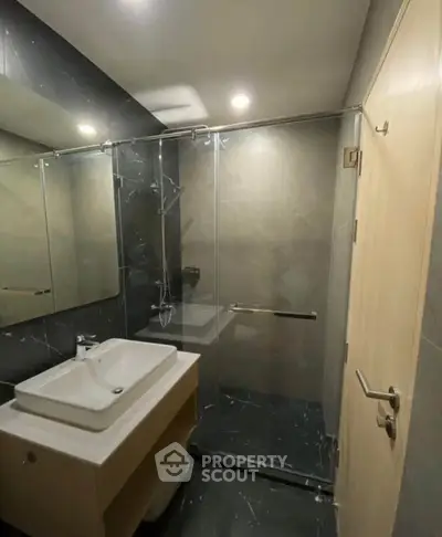 Modern bathroom with sleek design and glass shower enclosure