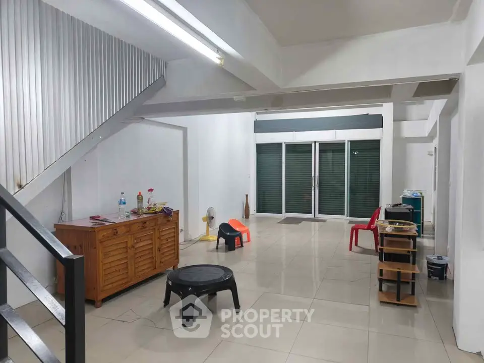 Spacious open-plan living area with modern minimalist design and ample natural light.