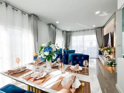 Luxurious open-plan living and dining area with elegant decor and natural light.