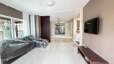 Spacious living room with modern decor and large windows offering natural light.
