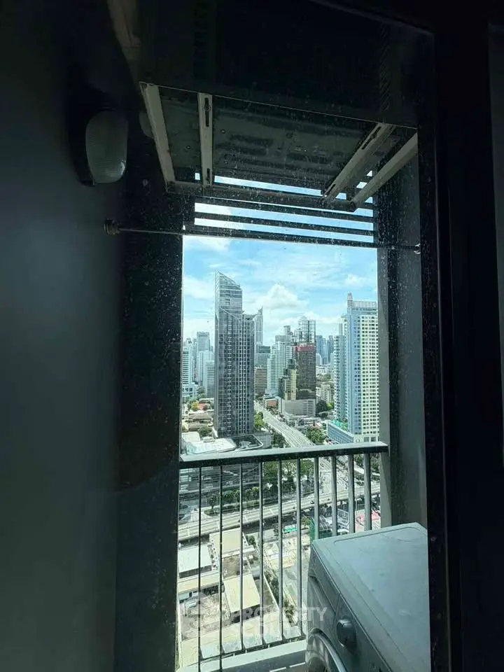 Stunning cityscape view from high-rise balcony with washing machine