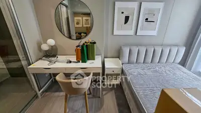 Modern bedroom with stylish decor, featuring a sleek desk, comfortable chair, and elegant bed setup.