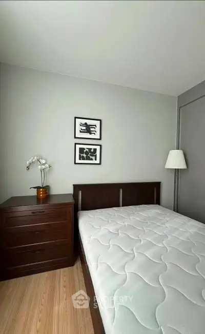 Modern bedroom with minimalist decor and wooden furniture