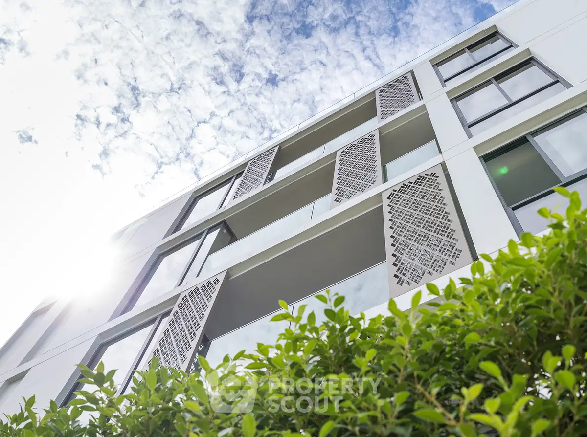 Modern architectural building with unique facade and lush greenery