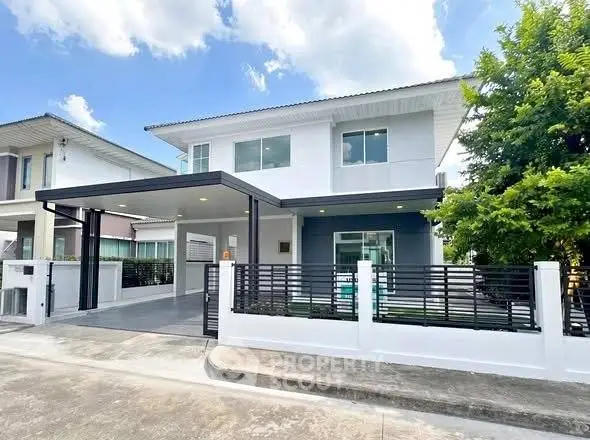 Modern two-story house with sleek design and spacious driveway in a serene neighborhood.