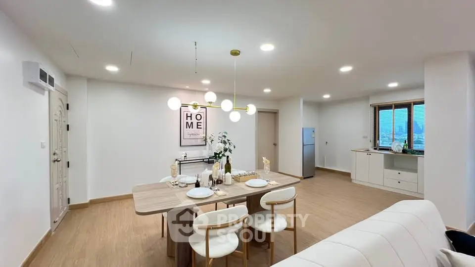 Modern open-plan living and dining area with stylish decor and natural light.