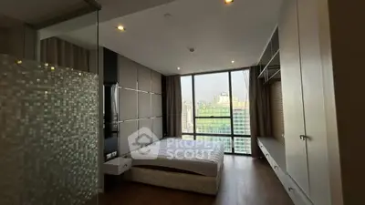 Modern bedroom with floor-to-ceiling windows and city view