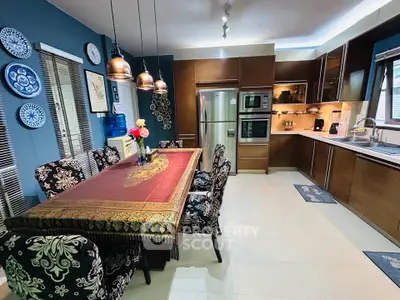 Elegant kitchen with dining area, featuring modern appliances and stylish decor, perfect for family gatherings.