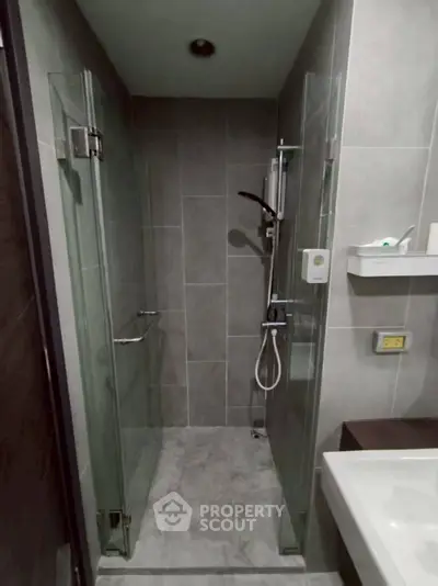 Modern bathroom with glass shower enclosure and sleek fixtures