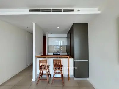 Modern kitchen with open layout and stylish bar seating in a contemporary apartment.