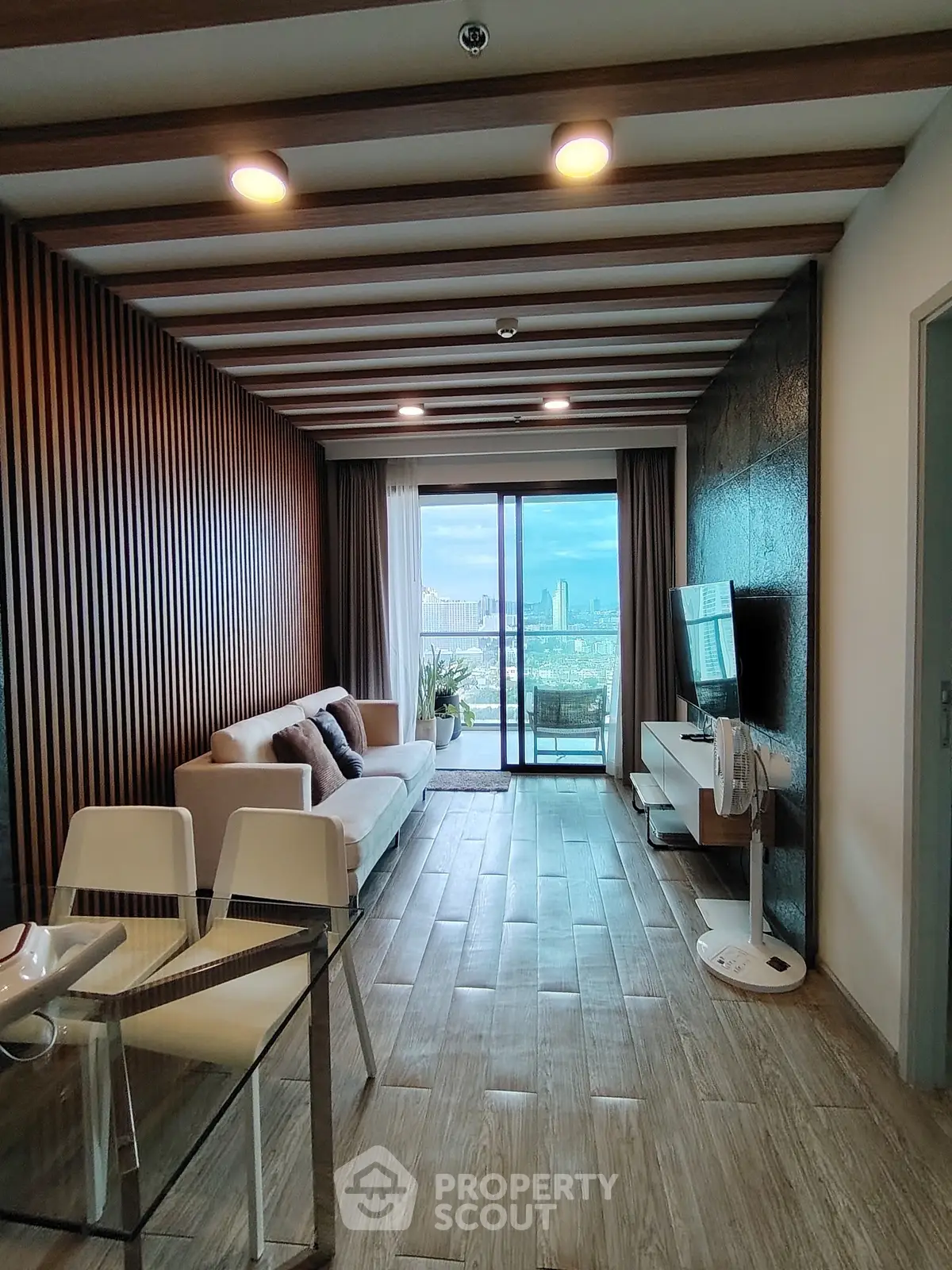 Modern living room with city view, stylish decor, and open layout