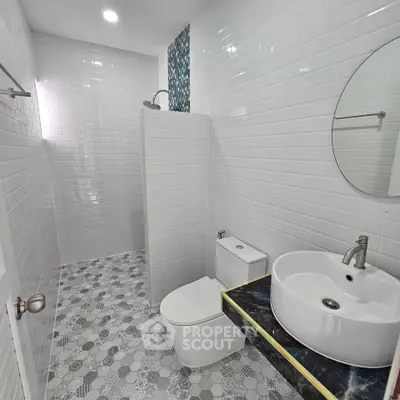 Modern bathroom with sleek white tiles and stylish fixtures